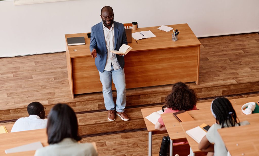 Teacher at college in lecture theatre